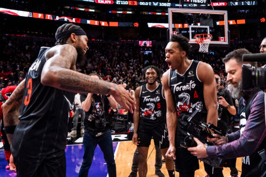 Brandon Ingram #3 of the Toronto Raptors celebrates with teammates Immanuel Quickley #5 and Scottie Barnes #4 after defeating the Charlotte Hornets at Scotiabank Arena.