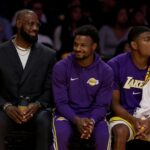 Los Angeles Lakers Lebron James, Bronny James and Rui Hachimura on the bench during the first half of an NBA basketball game at Crypto.com Arena on Tuesday, Oct. 21, 2025 in Los Angeles, CA.