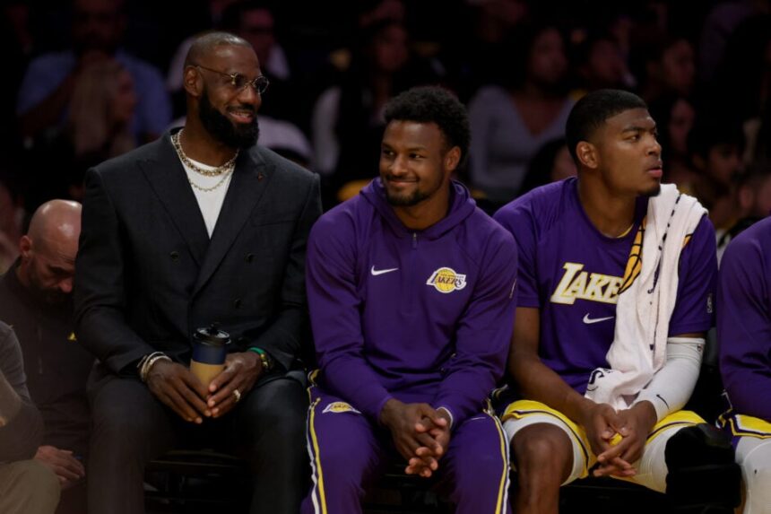 Los Angeles Lakers Lebron James, Bronny James and Rui Hachimura on the bench during the first half of an NBA basketball game at Crypto.com Arena on Tuesday, Oct. 21, 2025 in Los Angeles, CA.