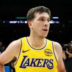Austin Reaves #15 of the Los Angeles Lakers celebrates his game-winning shot against the Minnesota Timberwolves after the game at Target Center.