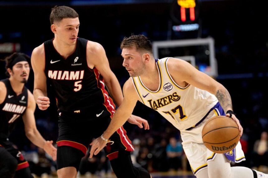 Los Angeles Lakers guard Luka Doncic (77) drives to the basket against Miami Heat forward Nikola Jovic (5) during the first half of an NBA basketball game at Crypto.com Arena.