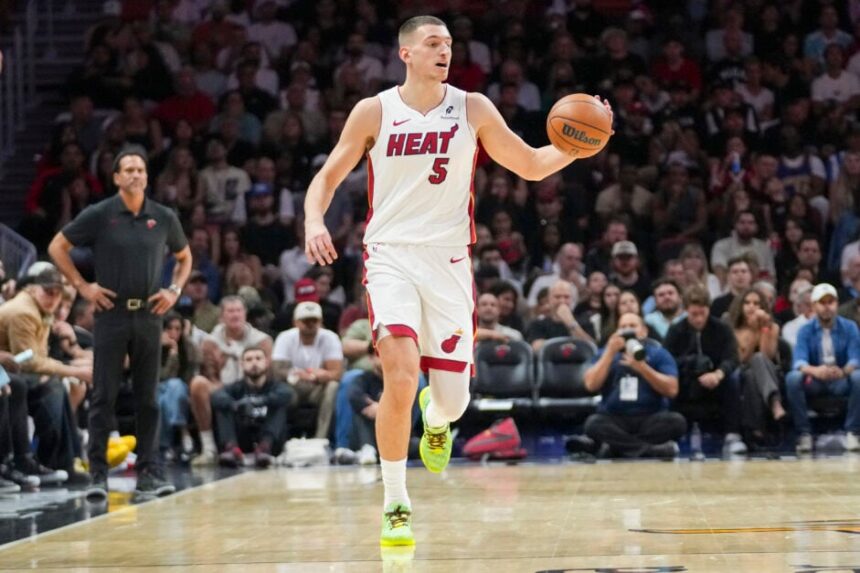 Nikola Jović #5 of the Miami Heat brings the ball down the court during the third quarter against the Portland Trail Blazers at Kaseya Center on November 08, 2025 in Miami, Florida.