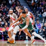 Giannis Antetokounmpo #34 of the Milwaukee Bucks battles for the ball against Scottie Barnes #4 of the Toronto Raptors during the second half at Scotiabank Arena.