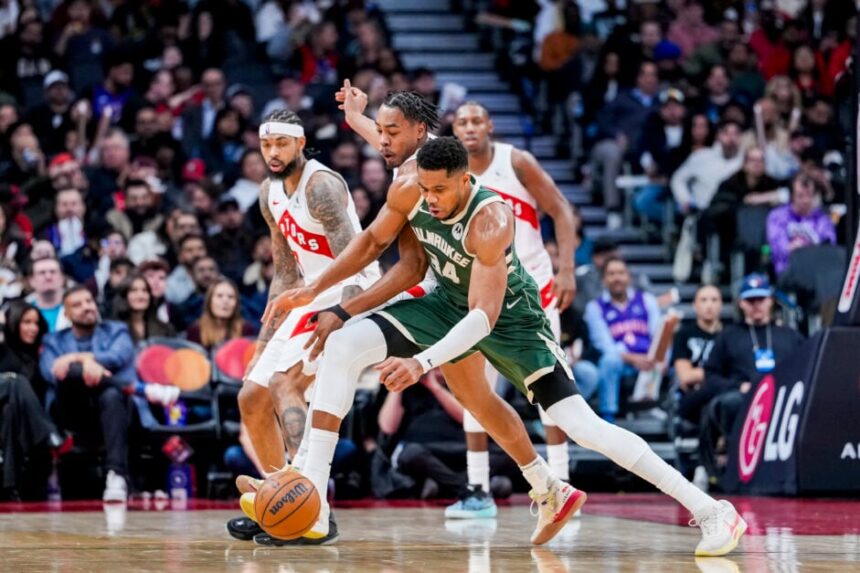 Giannis Antetokounmpo #34 of the Milwaukee Bucks battles for the ball against Scottie Barnes #4 of the Toronto Raptors during the second half at Scotiabank Arena.