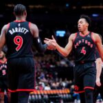 Scottie Barnes #4 and RJ Barrett #9 of the Toronto Raptors high-five during a break in play against the Washington Wizards during the second half of their basketball game at the Scotiabank Arena.