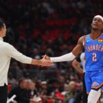 Head coach Mark Daigneault of the Oklahoma City Thunder high fives Shai Gilgeous-Alexander #2 against the Chicago Bulls during the second half at the United Center.