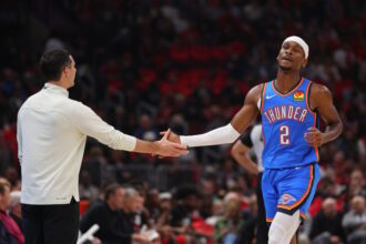 Head coach Mark Daigneault of the Oklahoma City Thunder high fives Shai Gilgeous-Alexander #2 against the Chicago Bulls during the second half at the United Center.
