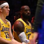 LeBron James #23 along with teammate Austin Reaves #15 of the Los Angeles Lakers on the bench during a time out against the Minnesota Timberwolves in the second half of a game 5 first round NBA basketball game at Crypto.com Arena.