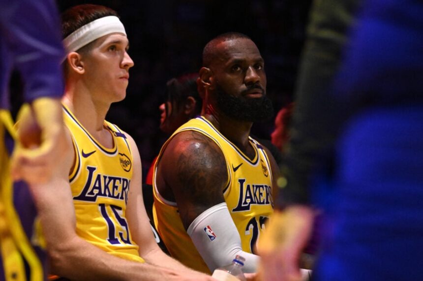 LeBron James #23 along with teammate Austin Reaves #15 of the Los Angeles Lakers on the bench during a time out against the Minnesota Timberwolves in the second half of a game 5 first round NBA basketball game at Crypto.com Arena.