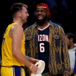 Los Angeles Lakers guard Luka Doncic (77) and forward LeBron James (23) interact during the first half of an NBA basketball game at Crypto.com Arena.