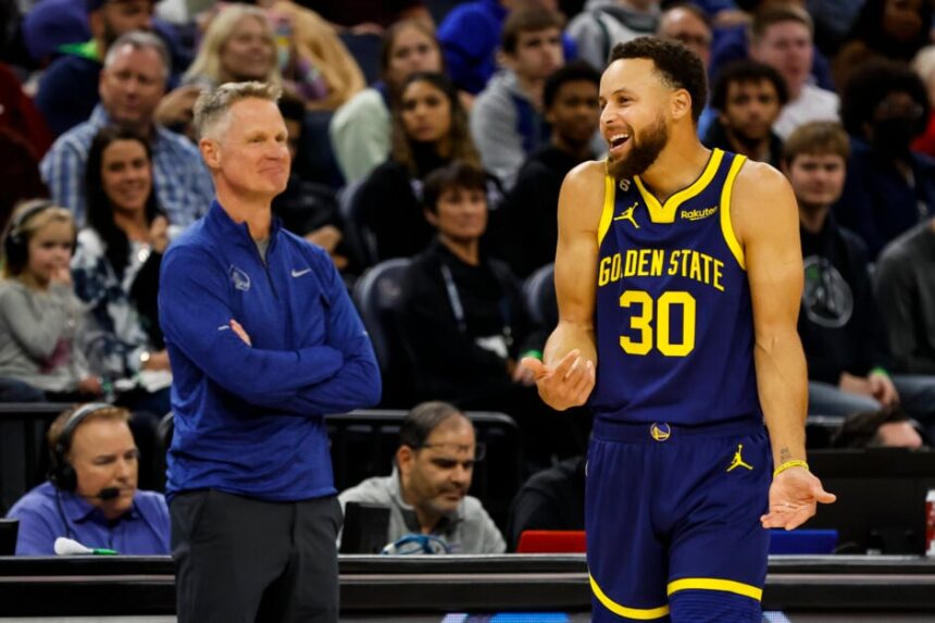 Stephen Curry #30 of the Golden State Warriors reacts to a call on the floor while head coach Steve Kerr looks on in the second quarter of the game against the Minnesota Timberwolves at Target Center on November 27, 2022 in Minneapolis, Minnesota.