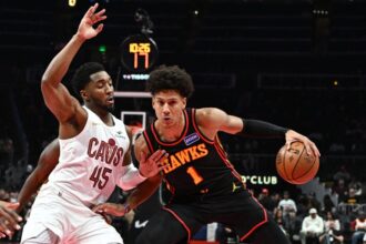 Jalen Johnson #1 of the Atlanta Hawks moves the ball against Donovan Mitchell #45 of the Cleveland Cavaliers in the first quarter during the 2025-26 Emirates NBA Cup.