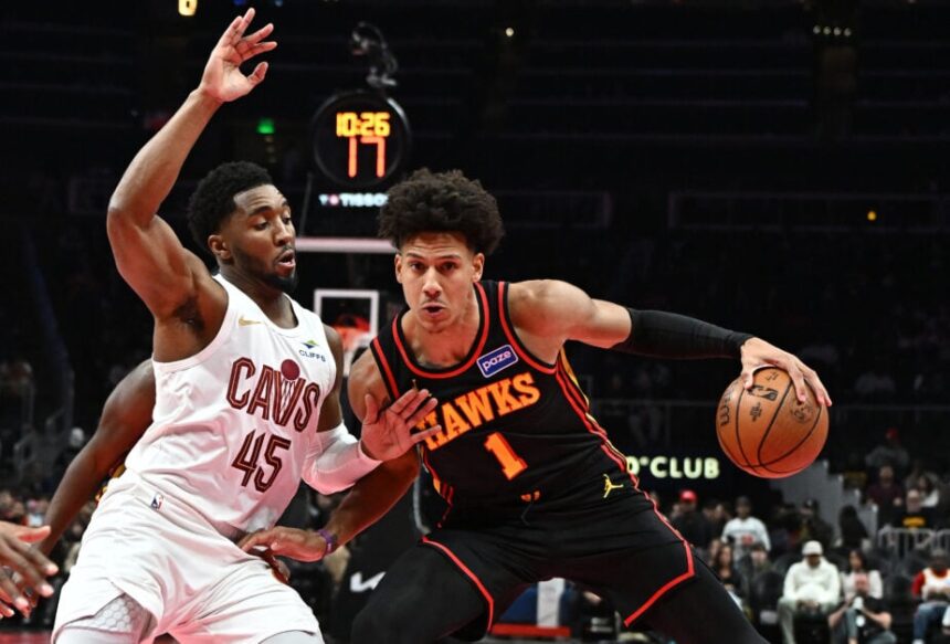 Jalen Johnson #1 of the Atlanta Hawks moves the ball against Donovan Mitchell #45 of the Cleveland Cavaliers in the first quarter during the 2025-26 Emirates NBA Cup.