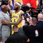 LA Lakers star LeBron James celebrates with Magic Johnson after becoming the all-time NBA scoring leader.
