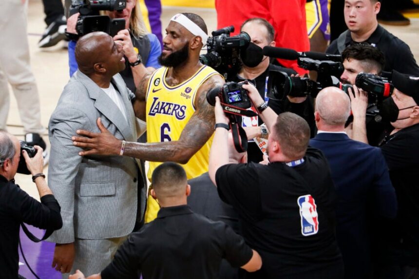 LA Lakers star LeBron James celebrates with Magic Johnson after becoming the all-time NBA scoring leader.