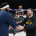 Anthony Davis #3 of the Dallas Mavericks and Luka Doncic #77 of the Los Angeles Lakers embrace after a preseason game at T-Mobile Arena.